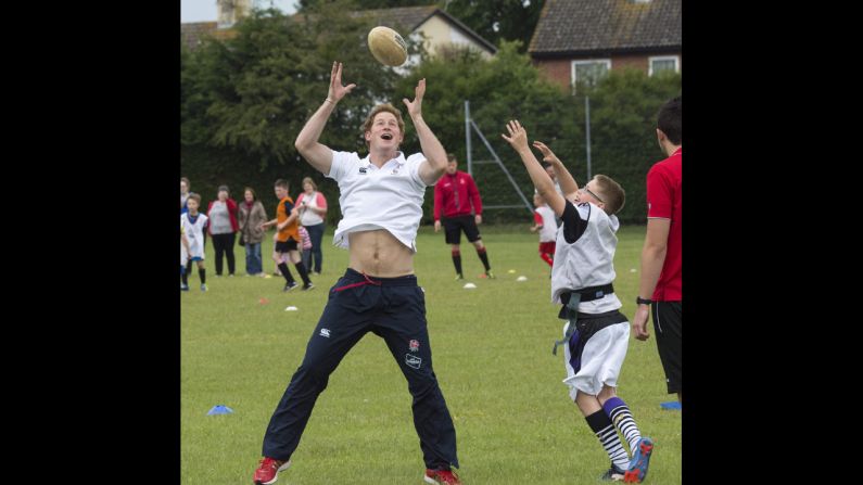 Britain's Prince Harry enjoys a game of touch rugby Thursday, May 29, at the Inspire Suffolk center in Ipswich, England. Inspire Suffolk is a local charity that uses sports to motivate and educate young children.