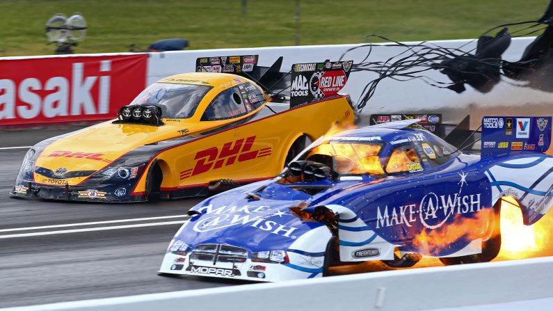 Fire is seen under the funny car of National Hot Rod Association driver Tommy Johnson Jr. during qualifying for the Summernationals event Saturday, May 31, at New Jersey's Raceway Park. It is not uncommon to see fire under funny cars and other drag racing vehicles as their engines are pushed to the limit.