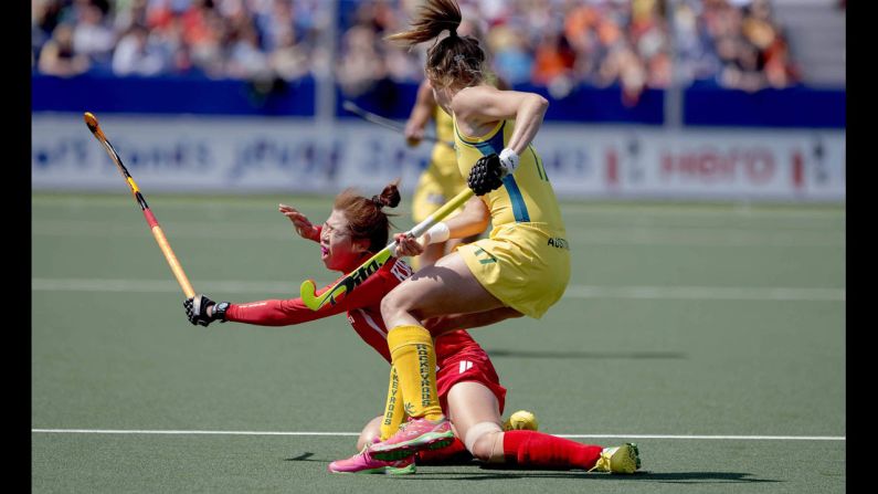 Australia's Emily Hurtz, right, and South Korea's Youngran Kim tussle for the ball during a match Saturday, May 31, at the Women's Hockey World Cup in The Hague, Netherlands. Australia won 3-2 in what was the opening match for both teams.
