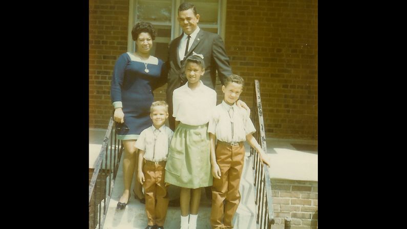 <a href="index.php?page=&url=http%3A%2F%2Fireport.cnn.com%2Fdocs%2FDOC-1119904">Michael T. Butler</a>, the little guy in the front row, and his well-dressed family members are seen here  in front of their home in Upper Marlboro, Maryland, in June 1969. "Life was slower, many of us hated the pace, but when we grew up, we returned to what we had lost," he said. "I moved back to the hometown of my youth because I was looking for what I had lost. Peace and quiet."