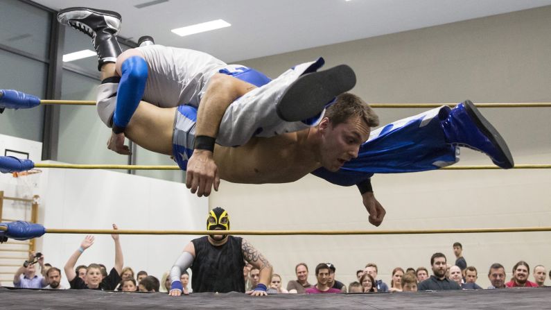 Pro wrestler Maik Tuga, bottom, fights Nacho Libres during a Swiss Championship Wrestling event held Saturday, May 31, in Zollikofen, Switzerland.