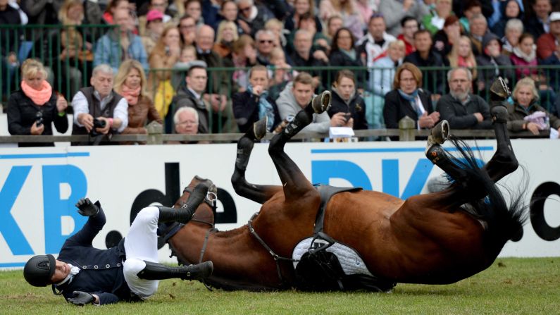 Marten Forkert and his horse, For Friendship, fall after failing to clear an obstacle at a show jumping event in Hamburg, Germany, on Sunday, June 1.