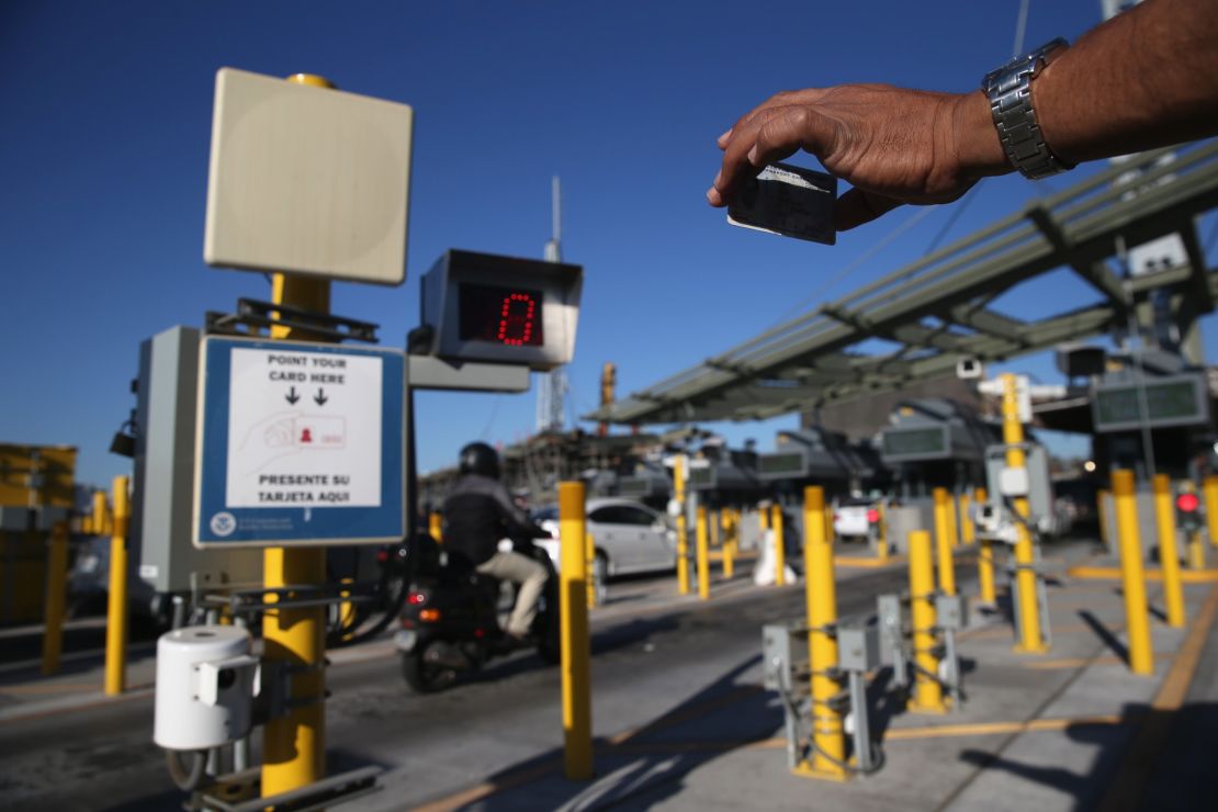 A traveler crossing into the U.S. from Mexico shows his ID to an automatic reader at San Ysidro, California.