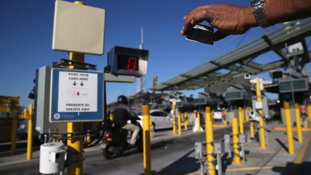 A traveler crossing into the U.S. from Mexico shows his ID to an automatic reader at San Ysidro, California.