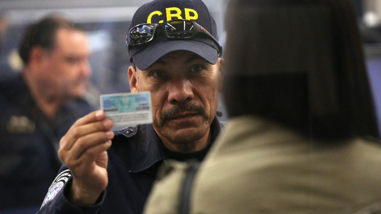 A U.S. Customs officer checks a person's ID at San Ysidro, California, where Sgt. Andrew Tahmooressi crossed into Mexico.