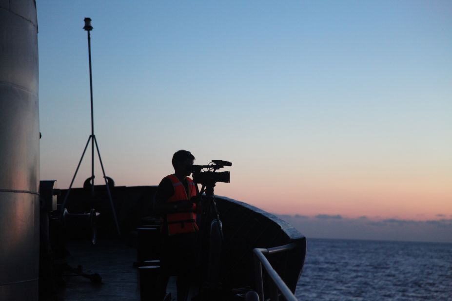 A cameraman films from the bow of CG8003. 