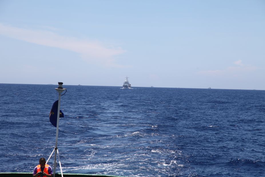A Chinese Coast Guard vessel follows CG 8003 at a discreet distance.