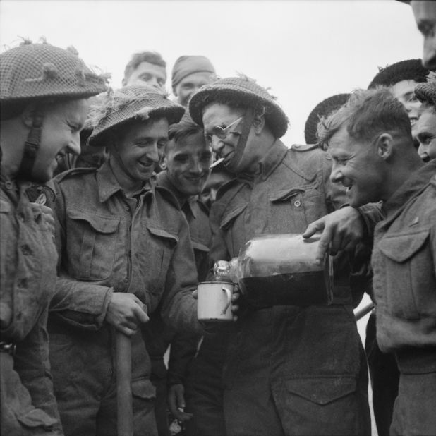 Lance Cpl. Walter Ray of the British Army shares a bottle of rum he found floating in the sea.