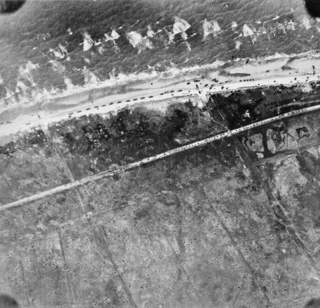 Traffic builds up on the beach and on the road leading to Le Hamel, France, during the landing of the 50th Infantry Division.