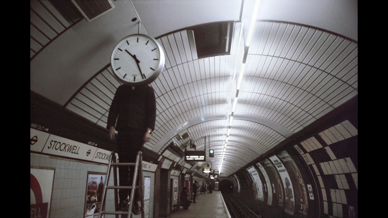 This image, from Stockwell station, has become known as "Clockwell." It was snapped the exact moment the man dropped his hands, Mazzer says. "It looks like he was just standing there but he was actually busy... all the time, and he [dropped his hands] for a moment." It was "just a one off -- there was no lead up, or lead off. It was just one shot." 