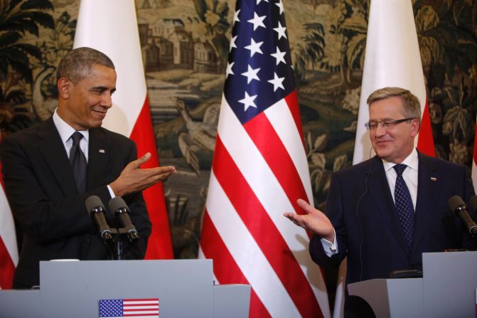 Obama and Komorowski gesture toward each other at a news conference in Warsaw on Tuesday, June 3.