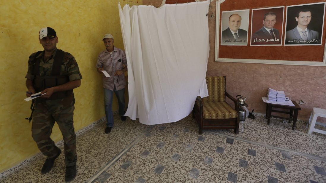 Syrians cast their votes at the Umm al-Zunnar church in Homs on June 3.