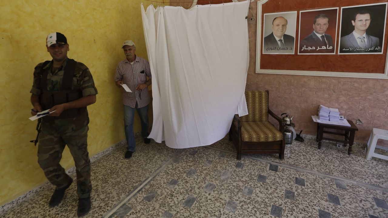 Syrians cast their votes at the Umm al-Zunnar church in Homs on June 3.