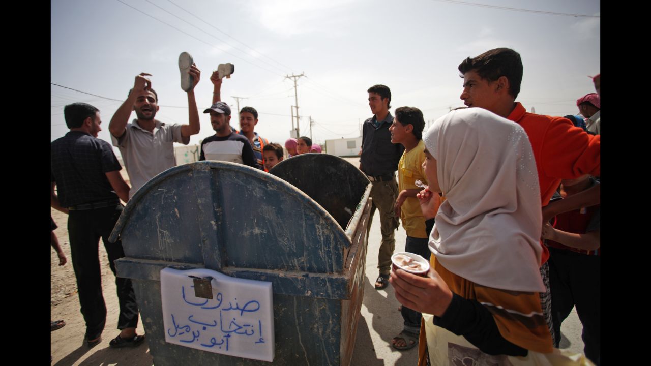 Syrian refugees at the Zaatari camp in Jordan put their shoes in a trash bin that reads "voting box" during a protest against the election on June 3.