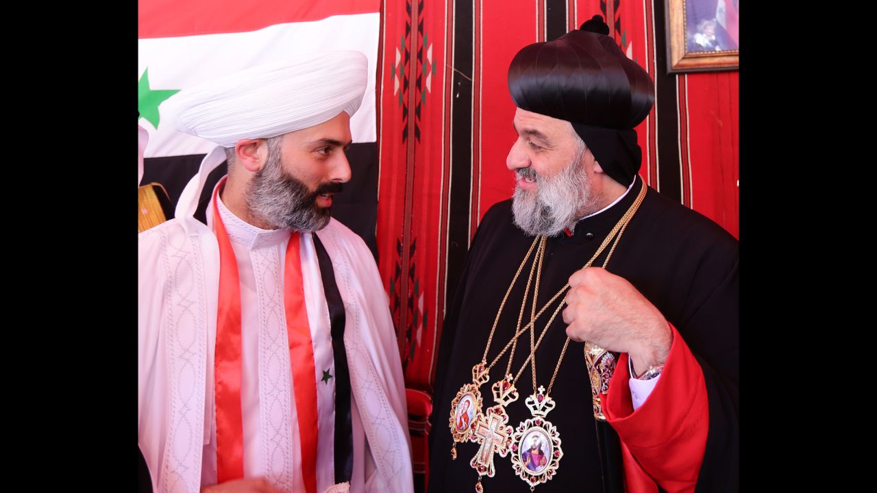 Ignatius Aphrem II, head of the Syriac Orthodox Church, right, arrives to vote in Damascus on June 3. 