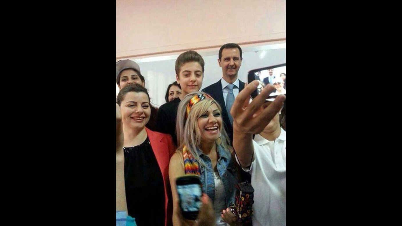 A handout picture released by the official Facebook page of Syrian first lady Asma al-Assad shows Syrian President Bashar al-Assad, back right, posing for a selfie with voters in Damascus, Syria, on Tuesday, June 3. Al-Assad is expected to win re-election <a href="http://www.cnn.com/2014/06/03/world/gallery/syria-elections/index.html">in a vote</a> that opposition groups and many Western countries say has been rigged from the start.