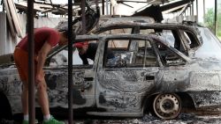 Teenagers examine burned cars near a Federal Border Headquarters building in the eastern Ukrainian city of Lugansk on June 3, 2014.