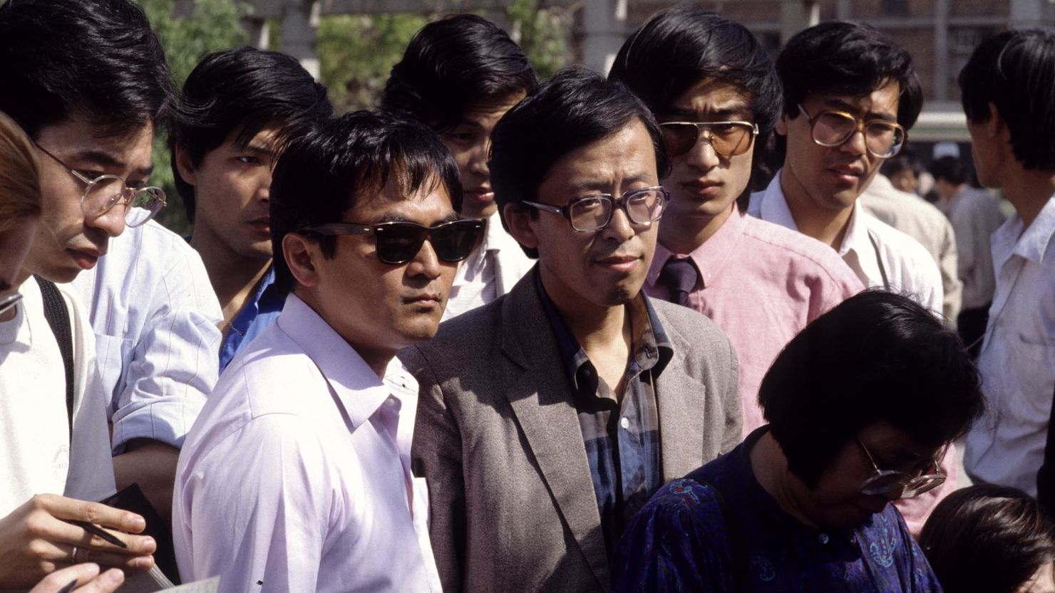 Jaime A. FlorCruz, then a TIME reporter, is seen in dark sunglasses in a crowd of journalists covering events in Beijing  in 1989.