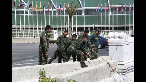 Soldiers pull barbed wire from a canal near the Thai Government House during a cleanup operation June 4 in Bangkok.