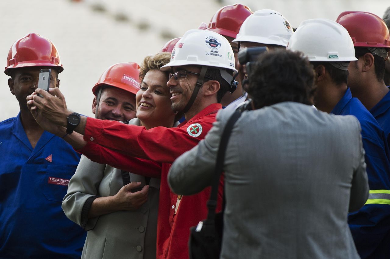 President Rousseff poses for a selfie with construction workers during a visit to the Arena Corinthians Stadium on May 8, 2014 which will host the opening match of the 2014 FIFA World Cup. 