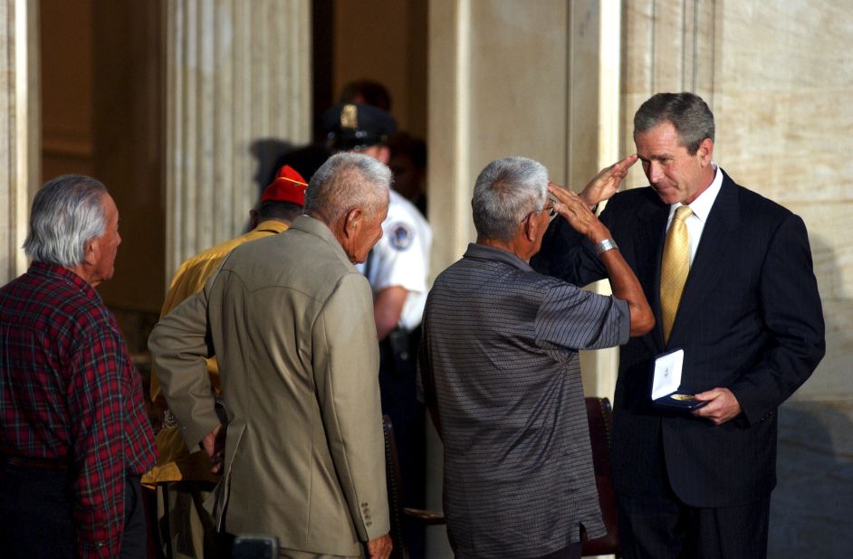 President George W. Bush salutes Nez while presenting him with the Congressional Gold Medal at the U.S. Capitol  in 2001.