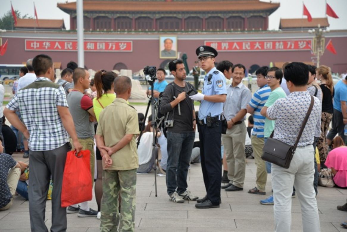 A foreign photographer is questioned and eventually taken away from Tiananmen Square on June 4.