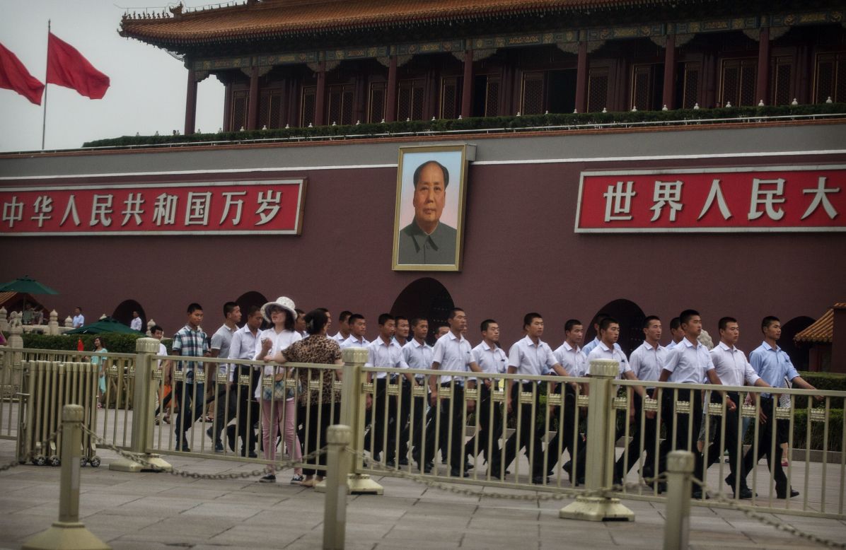 The police presence at Tiananmen Square was prominent on June 4. Plainclothes Chinese paramilitary police officers marched pass a portrait of the late leader Mao Zedong.
