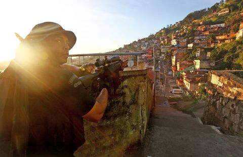 A police special forces officer holds his weapon during an operation in the Complexo do Alemao community, or 'favela' in Rio de Janeiro. Police in Brazil have forcibly occupied favelas in some of the country's biggest cities in the run up to the World Cup.