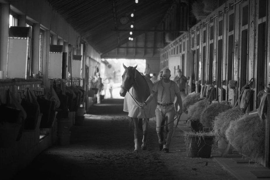 California Chrome, seen here with exercise rider Willie Delgado in his barn after training at Belmont, has been dubbed a horse racing "rock star."
