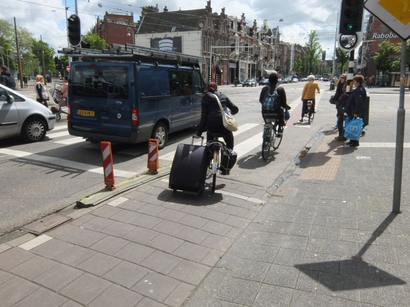 Why use the train to carry your suitcase the full 20 kilometers to Amsterdam's airport when you can cycle?