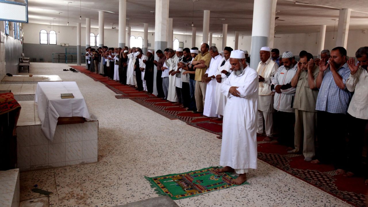 Friends and relatives pray over body of Abdelbaset Ali Mohmed al Megrahi during his funeral on May 21, 2012 in Janzur, Libya.