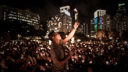 A man takes a picture with his mobile phone as people hold candles to commemorate China's 1989 Tiananmen Square events during a candlelight vigil in Hong Kong on June 4, 2014. Up to 200,000 people were set to take part in a candlelight vigil in Hong Kong on June 4 to commemorate the 25th anniversary of the bloody Tiananmen Square crackdown, as China seeks to wipe the incident from memory.