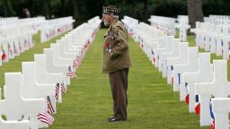 World War II veteran William Spriggs, 89, of the 83rd Infantry Division and who took part in the invasion of Normandy, searches for fallen comrades in the Normandy American Cemetery June 5, 2014 in Colleville-sur-Mer, France.