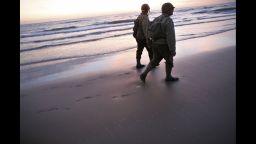 World War II re-enactors walk along Omaha Beach in Vierville sur Mer, France, on Friday, June 6, the 70th anniversary of D-Day.