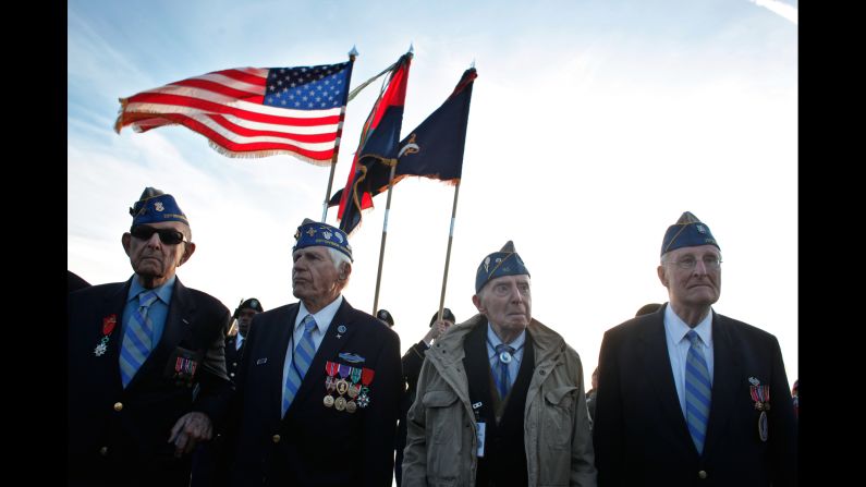 World War II veterans from the U.S. 29th Infantry Division, from left, Hal Baumgarter, Steve Melnikoff, Don McCarthy and Morley Piper attend a D-Day commemoration on Omaha Beach.