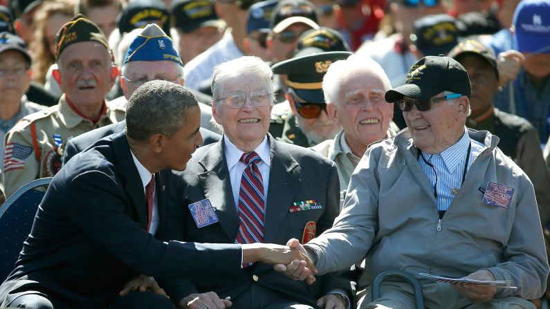 President Obama greets veterans during the ceremony at the Normandy American Cemetery.