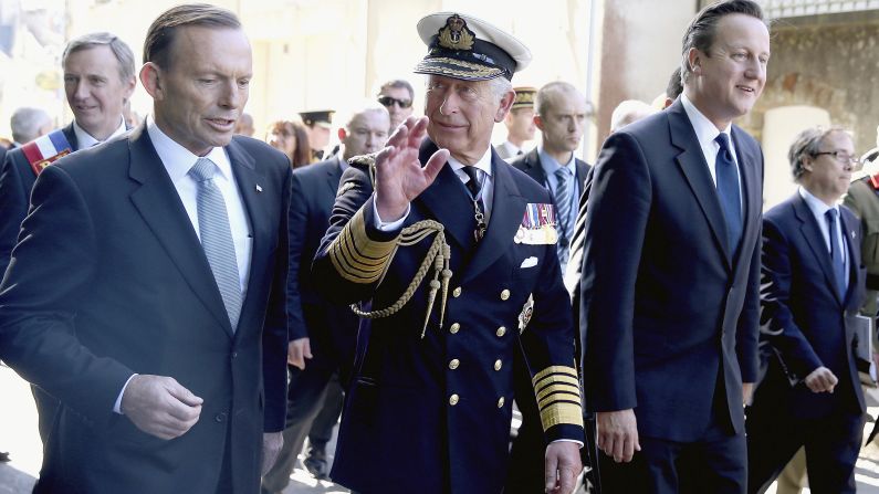 From left, Australian Prime Minister Tony Abbott, Britain's Prince Charles and British Prime Minister David Cameron walk through Bayeux after the ceremony.