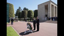 President Barack Obama and French President Francois Hollande pause for a moment of silence after laying a wreath at the Normandy American Cemetery in Colleville sur Mer, France, on Friday, June 6, the 70th anniversary of D-Day.