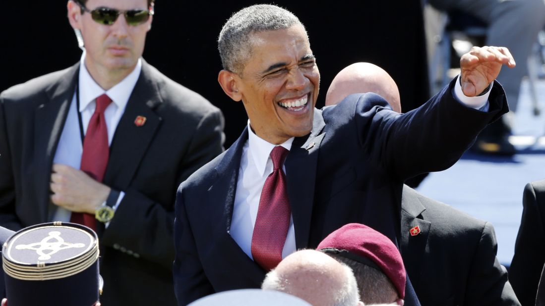 President Obama waves during a D-Day ceremony.