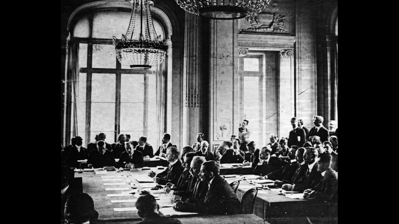 German delegates listen to French Prime Minister Georges Clemenceau's speech during the signing of the Treaty of Versailles in France on June 28, 1919.