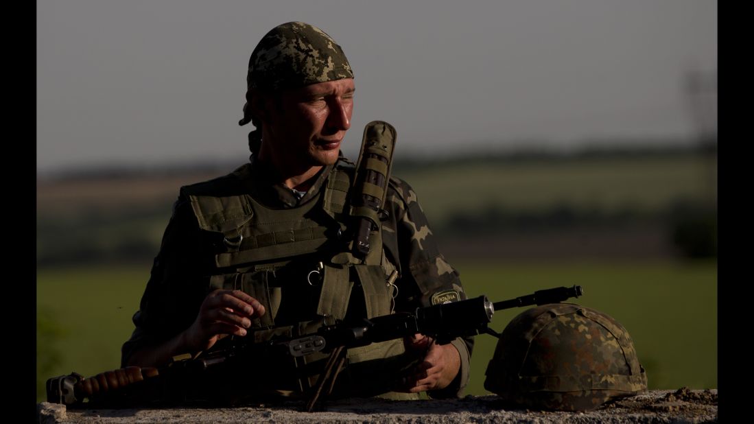 A Ukrainian soldier observes the road at a checkpoint outside of Amvrosiivka, Ukraine, on Thursday, June 5.