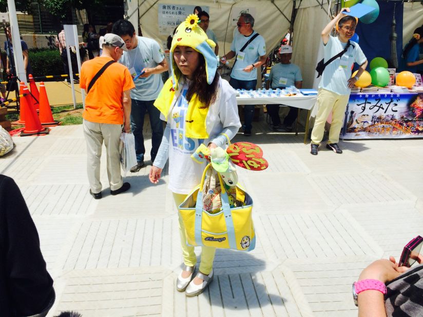 Tokyo resident Mika Asano, 32, poses with some of her Funassyi merchandise, which she estimates cost her more than $1,000. Mascots appeal to people of all ages in Japan, with many adult fans.