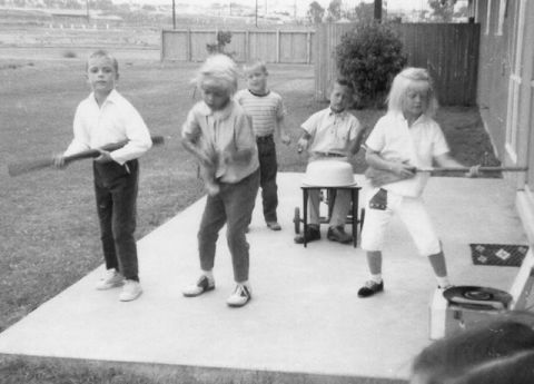 <a href="http://ireport.cnn.com/docs/DOC-1137102">Mora Pieti-Alcorn</a> took this photo as the younger kids followed his and his friends' lead in putting on a "Beatles show" in their Oceanside, California military neighborhood in the summer of 1964. "How carefree our summer days were," she remembered. "Living on       base is very uniting and even though military families move around a lot you always  seem to end up together again and again through out the years."