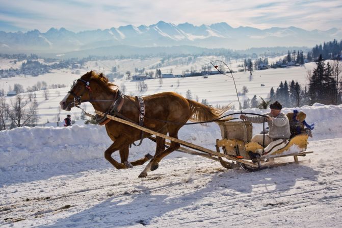 A sleigh rider is carried through the Malopolska region of <a href="http://www.poland.travel/en/nature/tatra-national-park" target="_blank" target="_blank">Tatra National Park</a> in Poland. <a href="http://ireport.cnn.com/docs/DOC-1138891">Adrian Lukas Smith took</a> this photo and works closely with the park. He says his favorite part of this region is the landscape and the Tatra Mountains, which are a natural border between Poland and Slovakia.