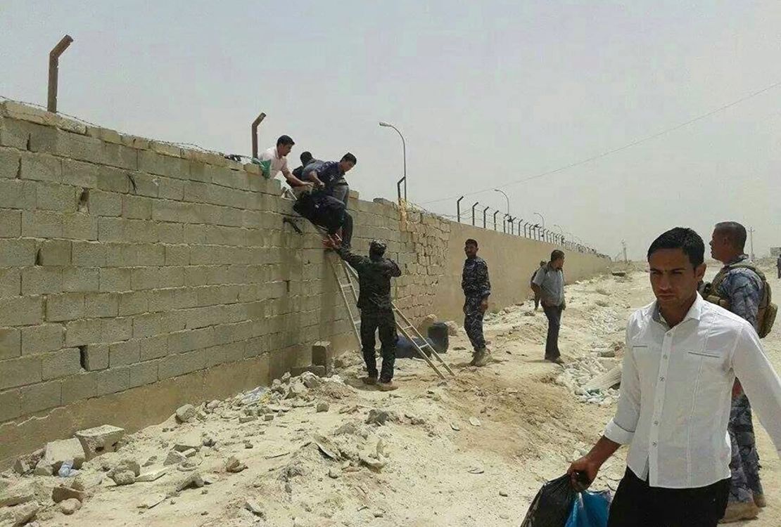 Students of Anbar university leave the university building in Ramadi city, in western Iraq, on Saturday, June 7. 