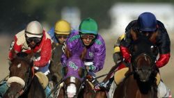 California Chrome, center, is flanked by Wicked Strong, left, and Tonalist, right, as they run down the backstretc.