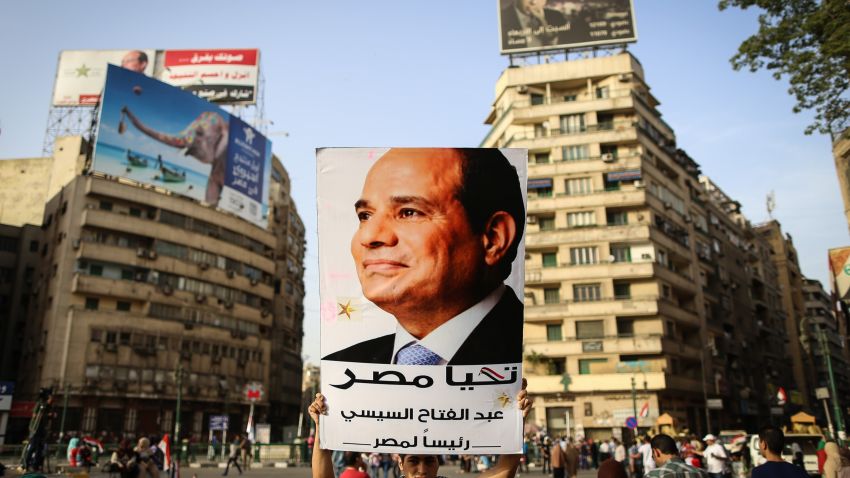 An Egyptian man holds up a portrait of ex-army chief Abdel Fattah al-Sisi as he celebrates in Cairo's Tahrir Square on June 3, 2014 after Sisi won 96.9 percent of votes in the country's presidential election. 