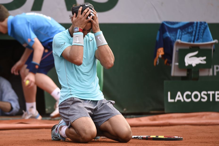 Rafael Nadal sinks to his knees in triumph after his four-set victory over Novak Djokovic in the French Open final.