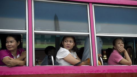 Passengers on a bus watch soldiers entertain the crowds at Bangkok's Victory Monument on June 5. 