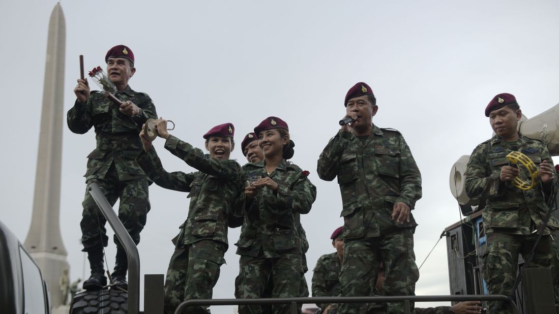 Thai soldiers entertain people with songs at Victory Monument in Bangkok on Thursday, June 5. The junta is waging a propaganda campaign to encourage "national happiness" following the coup that severely restricted civil liberties. 